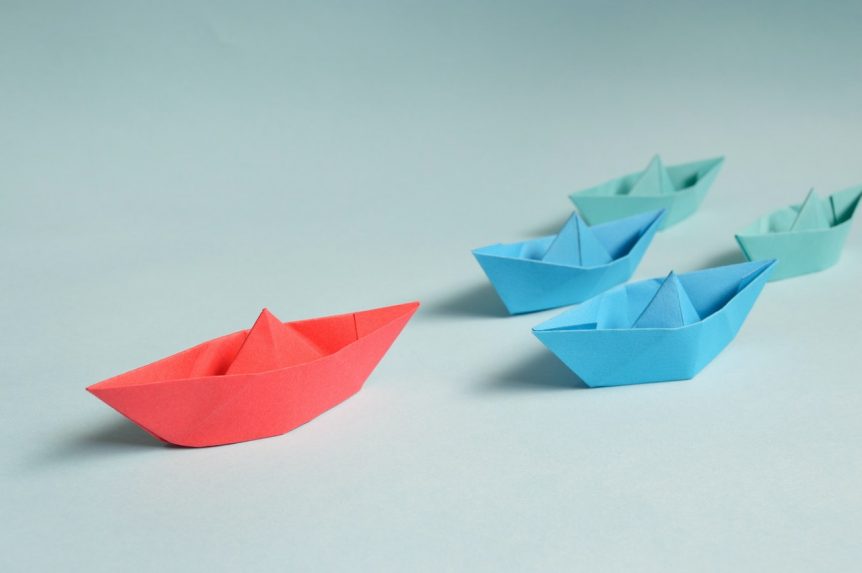 leader-paper-boats-on-solid-surface
